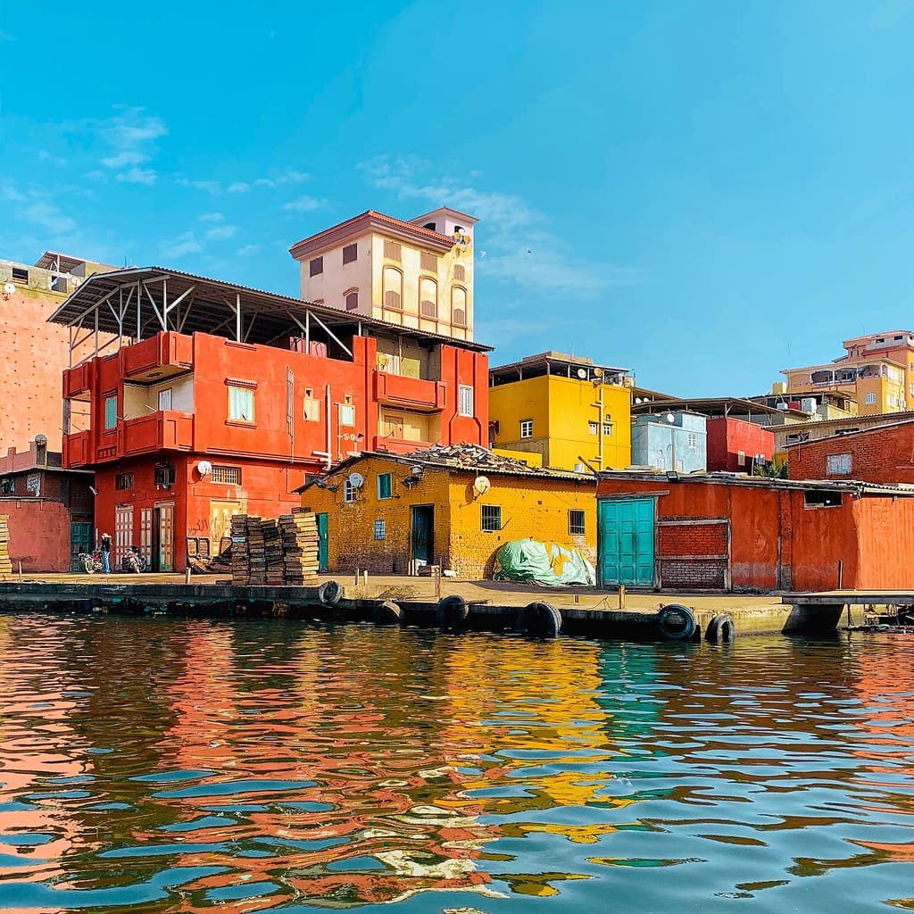 A photo of variouse houses by the canal side in Egypt