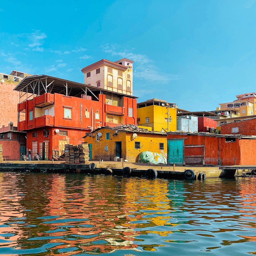 A photo of variouse houses by the canal side in Egypt